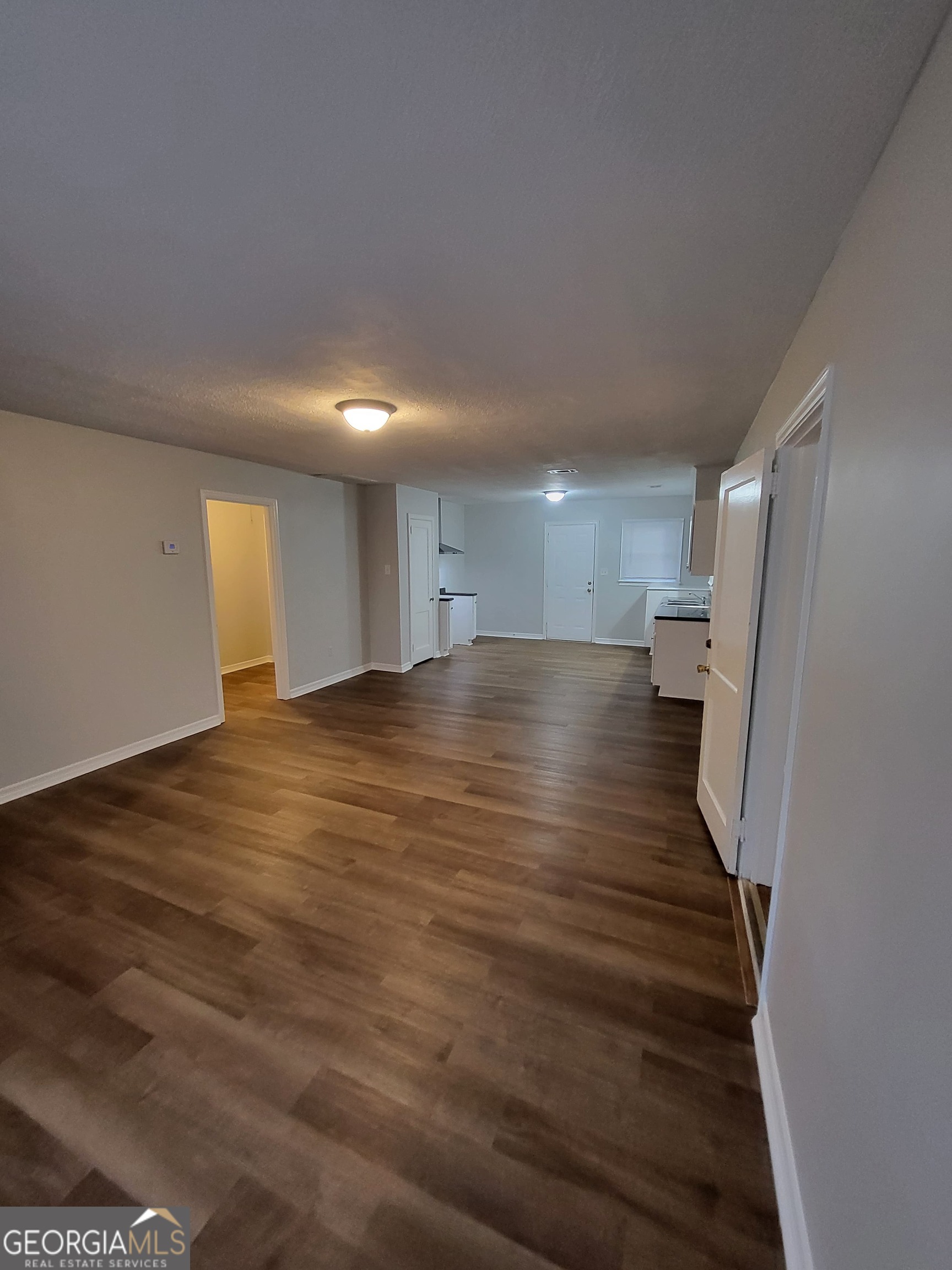 1710 West Highland Avenue Albany, GA 31707 - Photo 2 of 5 a view of a big room with wooden floor and windows