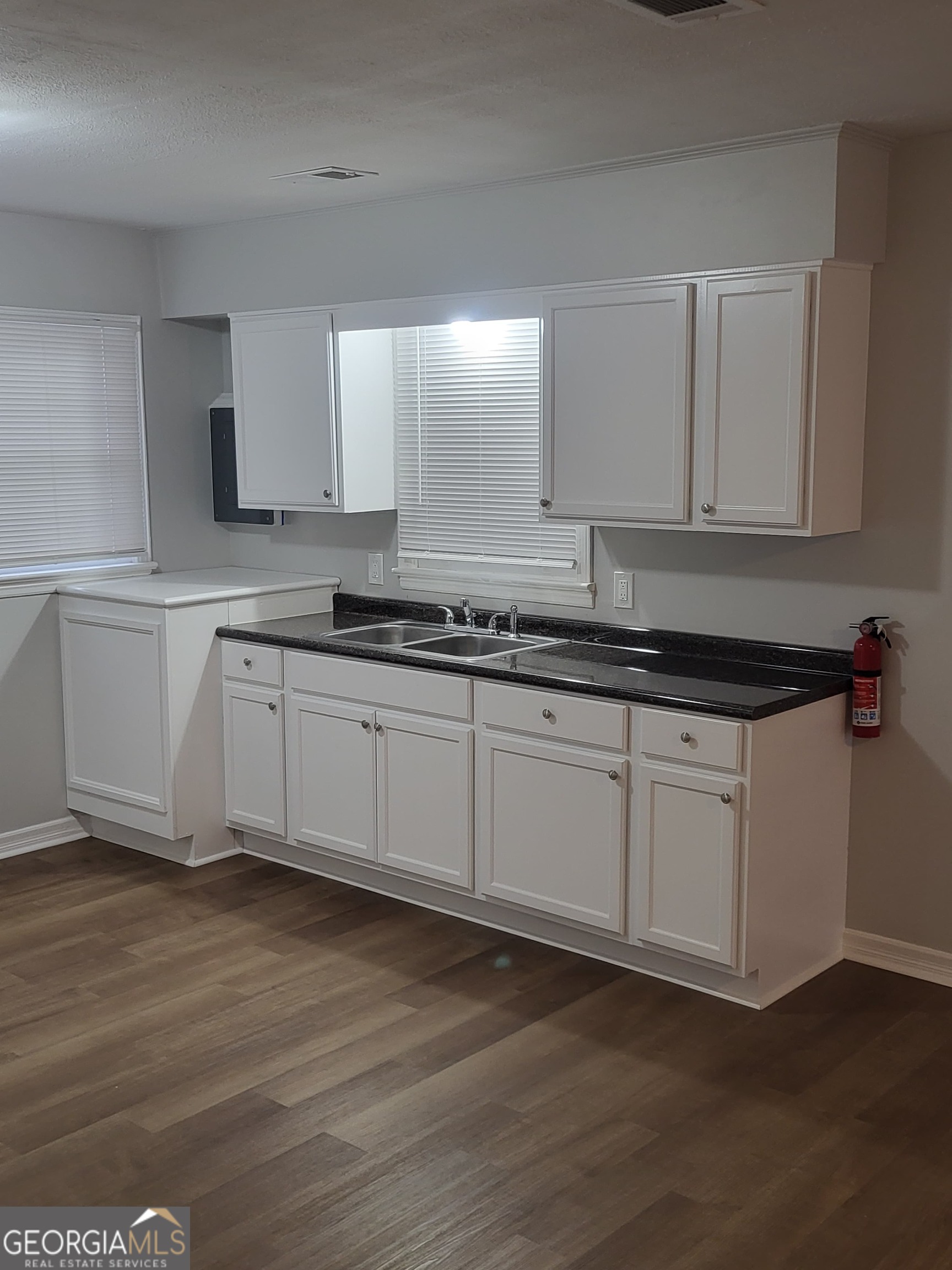 1710 West Highland Avenue Albany, GA 31707 - Photo 4 of 5 a kitchen with a sink cabinets and wooden floor