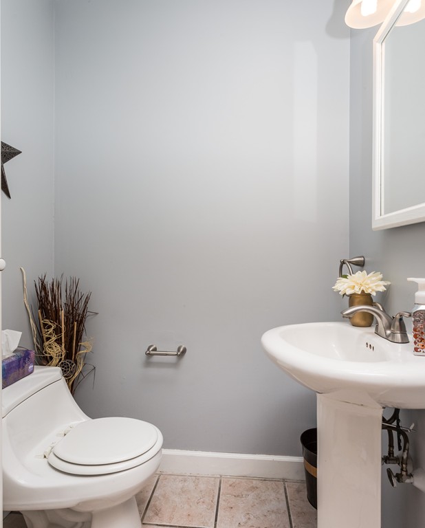 82 Dwight Road Springfield, MA 01108 - Photo 17 of 28 a bathroom with a sink a toilet and mirror