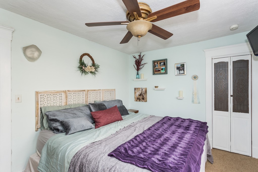 82 Dwight Road Springfield, MA 01108 - Photo 22 of 28 a bedroom with a large bed and a chandelier