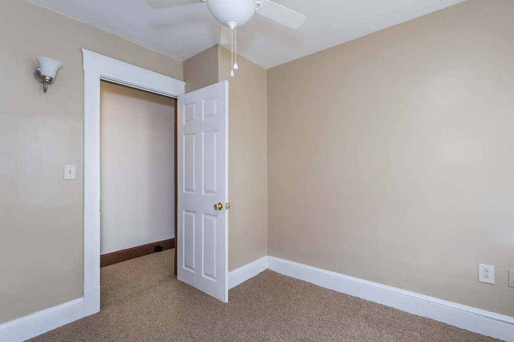82 Dwight Road Springfield, MA 01108 - Photo 24 of 28 an empty room with a empty space and a ceiling fan