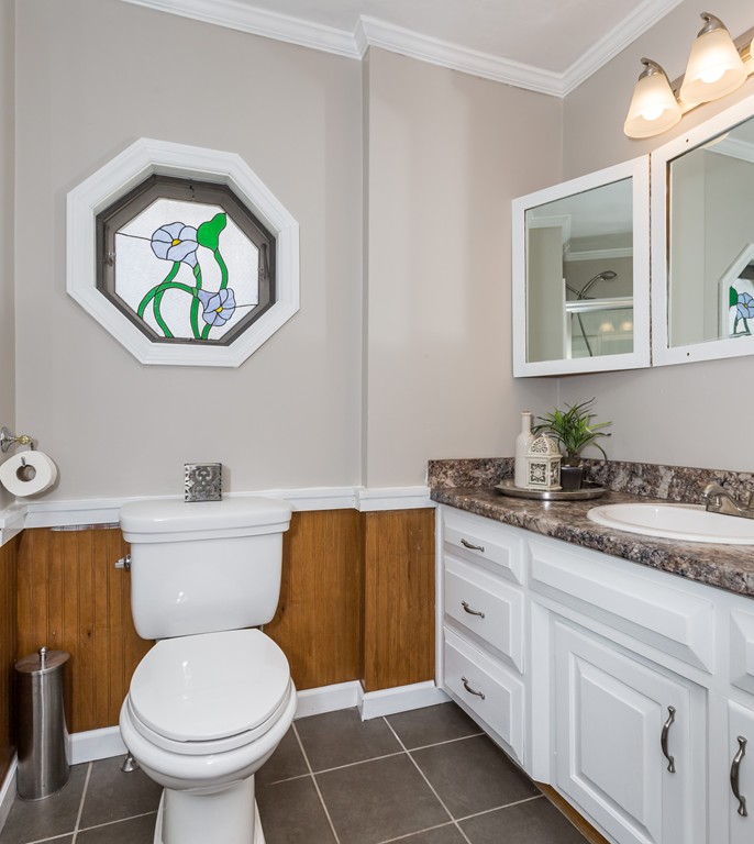 82 Dwight Road Springfield, MA 01108 - Photo 25 of 28 a bathroom with a toilet a sink and a mirror