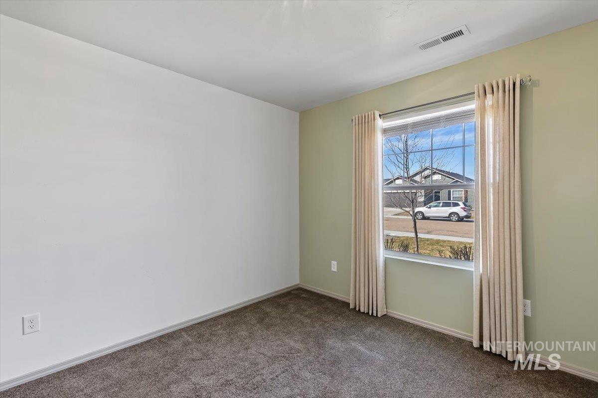 12781 Ashfield Street Caldwell, ID 83607 - Photo 27 of 36 Unfurnished room with dark carpet and baseboards