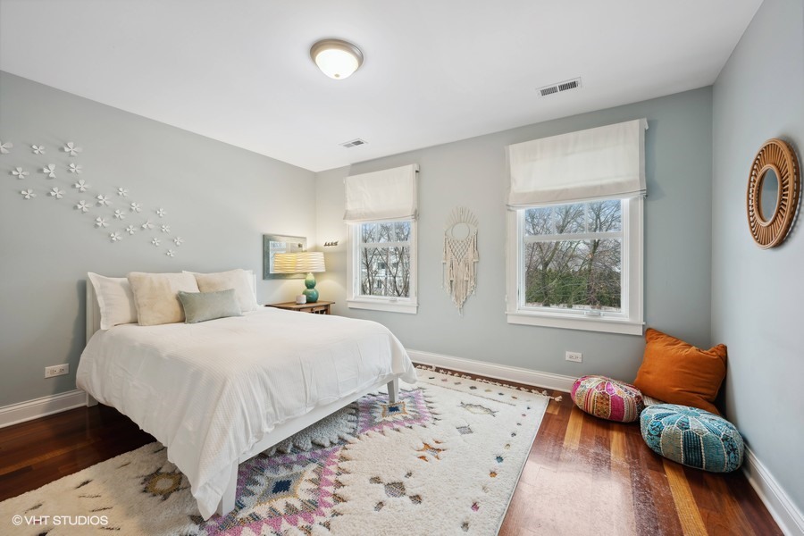 807 Cherry Street Winnetka, IL 60093 - Photo 19 of 37 a bedroom with a bed and wooden floor