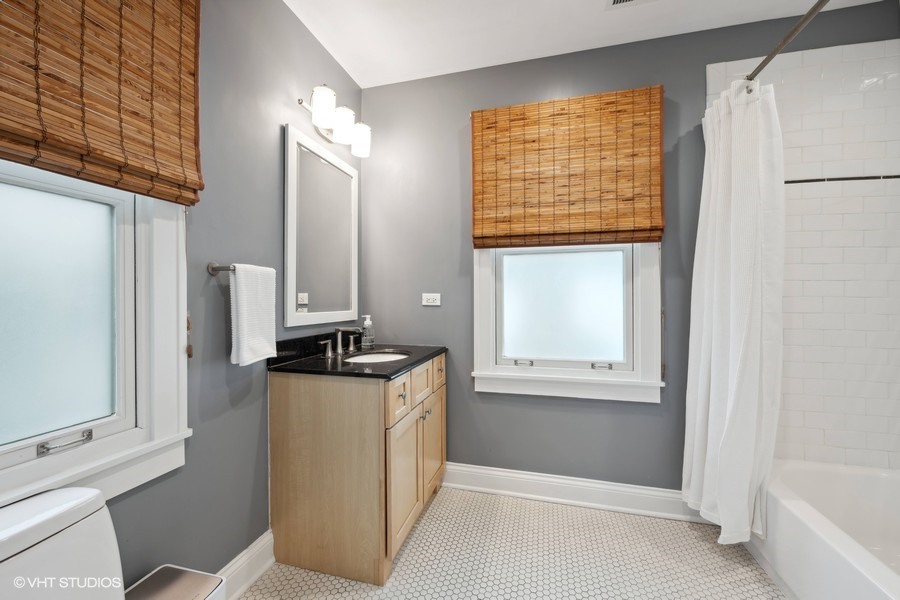 807 Cherry Street Winnetka, IL 60093 - Photo 21 of 37 a bathroom with a granite countertop sink a mirror and a bathtub