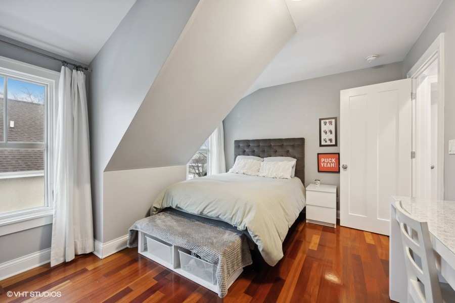 807 Cherry Street Winnetka, IL 60093 - Photo 22 of 37 a bedroom with a bed and wooden floor