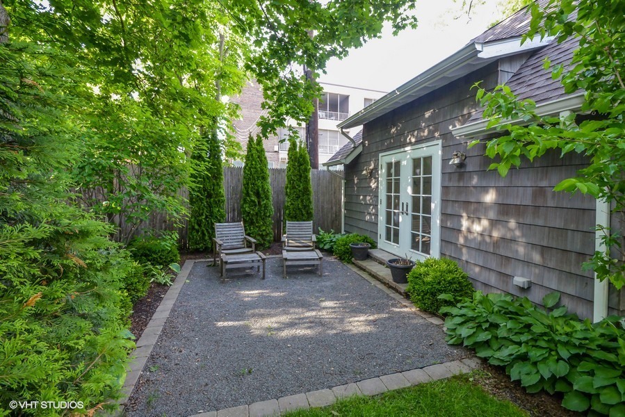 807 Cherry Street Winnetka, IL 60093 - Photo 32 of 37 a view of a patio with table and chairs potted plants and large tree