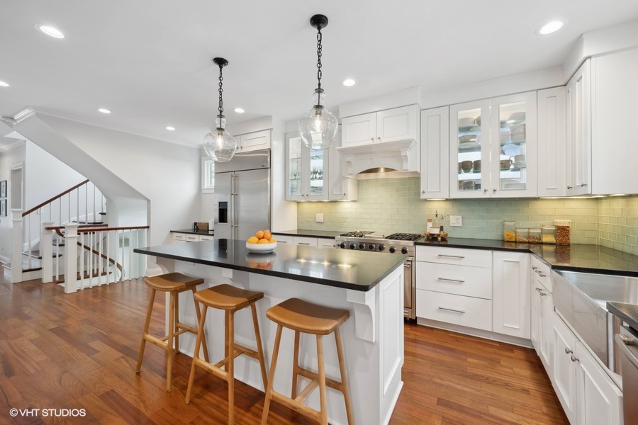 807 Cherry Street Winnetka, IL 60093 - Photo 6 of 37 a kitchen with stainless steel appliances granite countertop a kitchen island hardwood floor sink stove and white cabinets