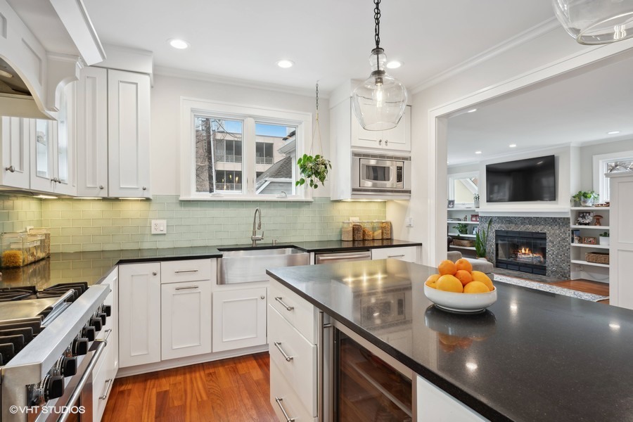 807 Cherry Street Winnetka, IL 60093 - Photo 7 of 37 a kitchen with granite countertop a sink a stove top oven a counter space and cabinets