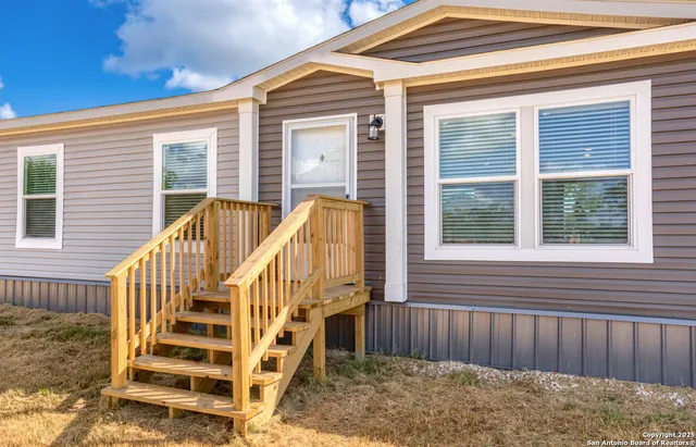a view of wooden house with a large window