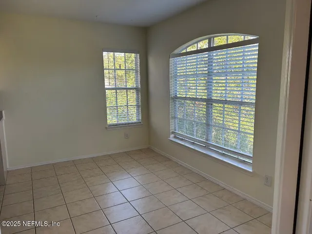 a view of an empty room with windows