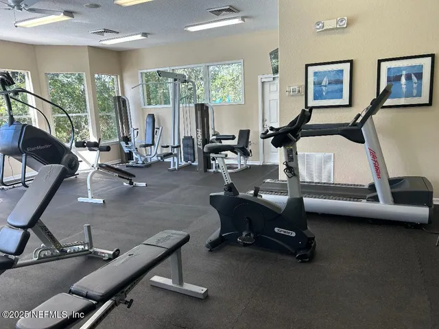 a room with gym equipment and a large window