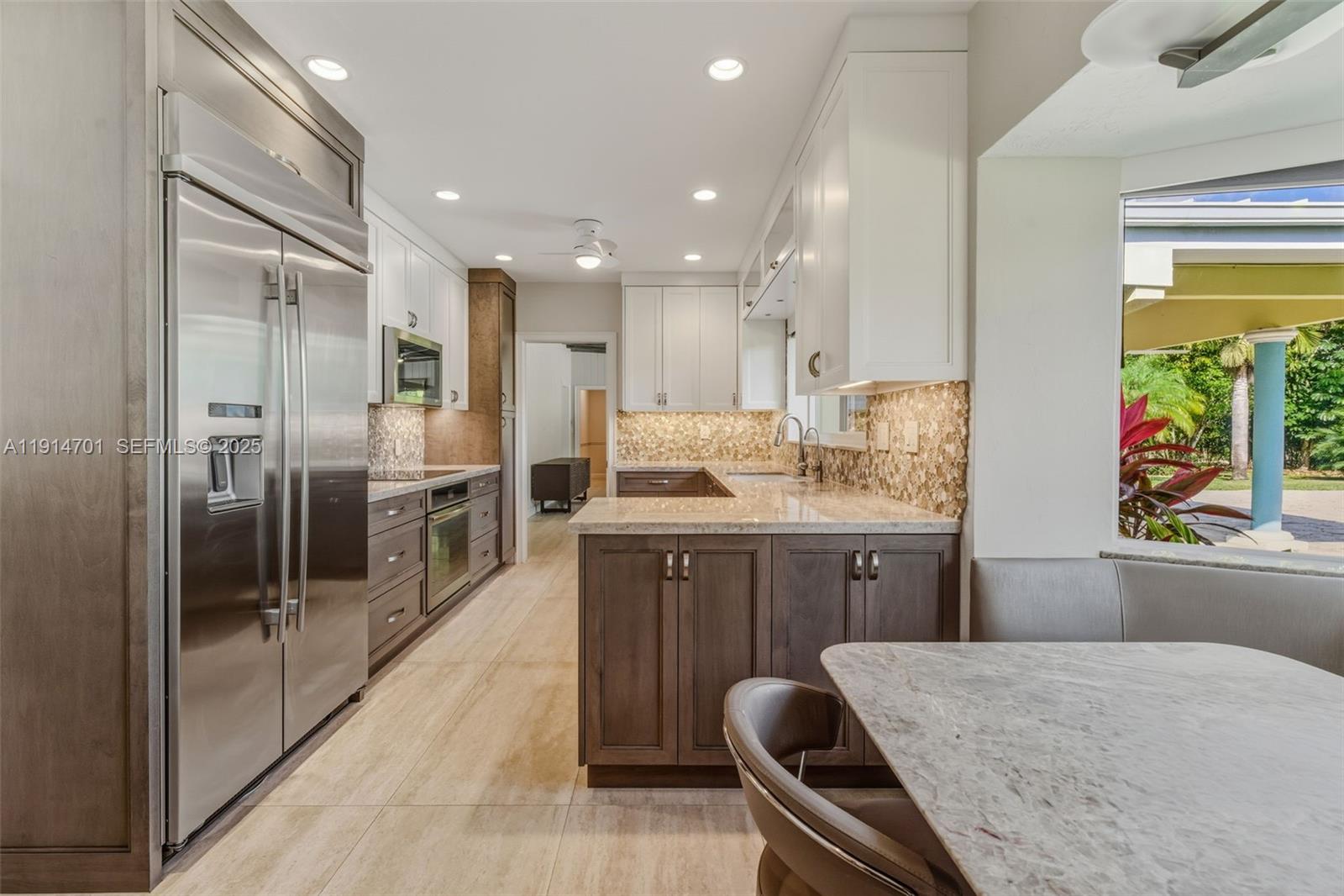 8001 Southwest 66th Terrace Miami, FL 33143 - Photo 12 of 35 a kitchen with counter top space cabinets and stainless steel appliances