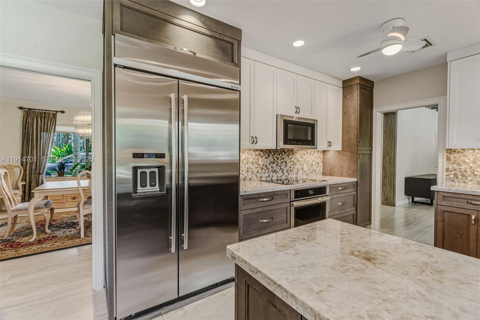 8001 Southwest 66th Terrace Miami, FL 33143 - Photo 14 of 35 a kitchen with a refrigerator and a stove top oven