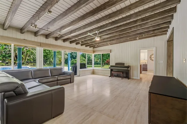 a bedroom with a bed and dresser with mirror