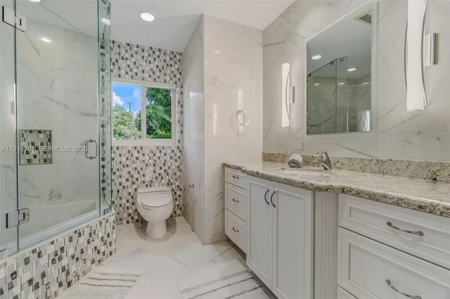 a bathroom with a shower and a sink