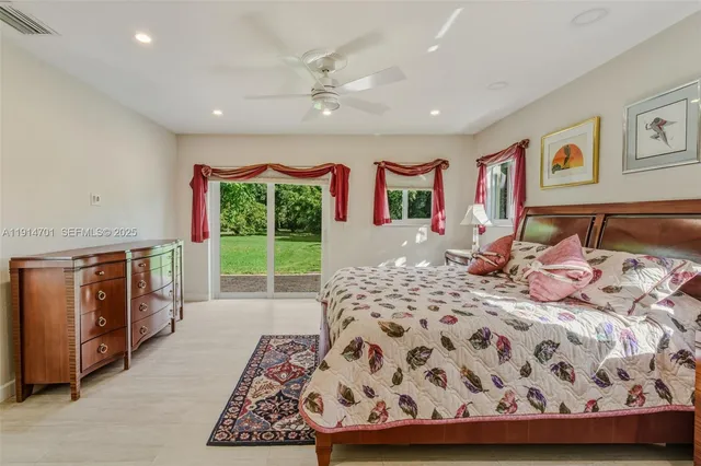 a large en suite bathroom with a granite countertop sink mirror and shower