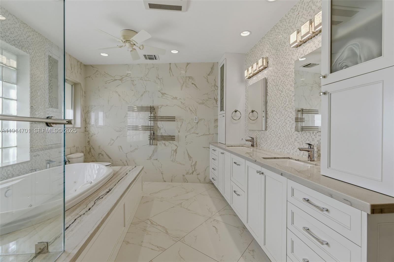 8001 Southwest 66th Terrace Miami, FL 33143 - Photo 21 of 35 a large en suite bathroom with a granite countertop sink mirror and shower