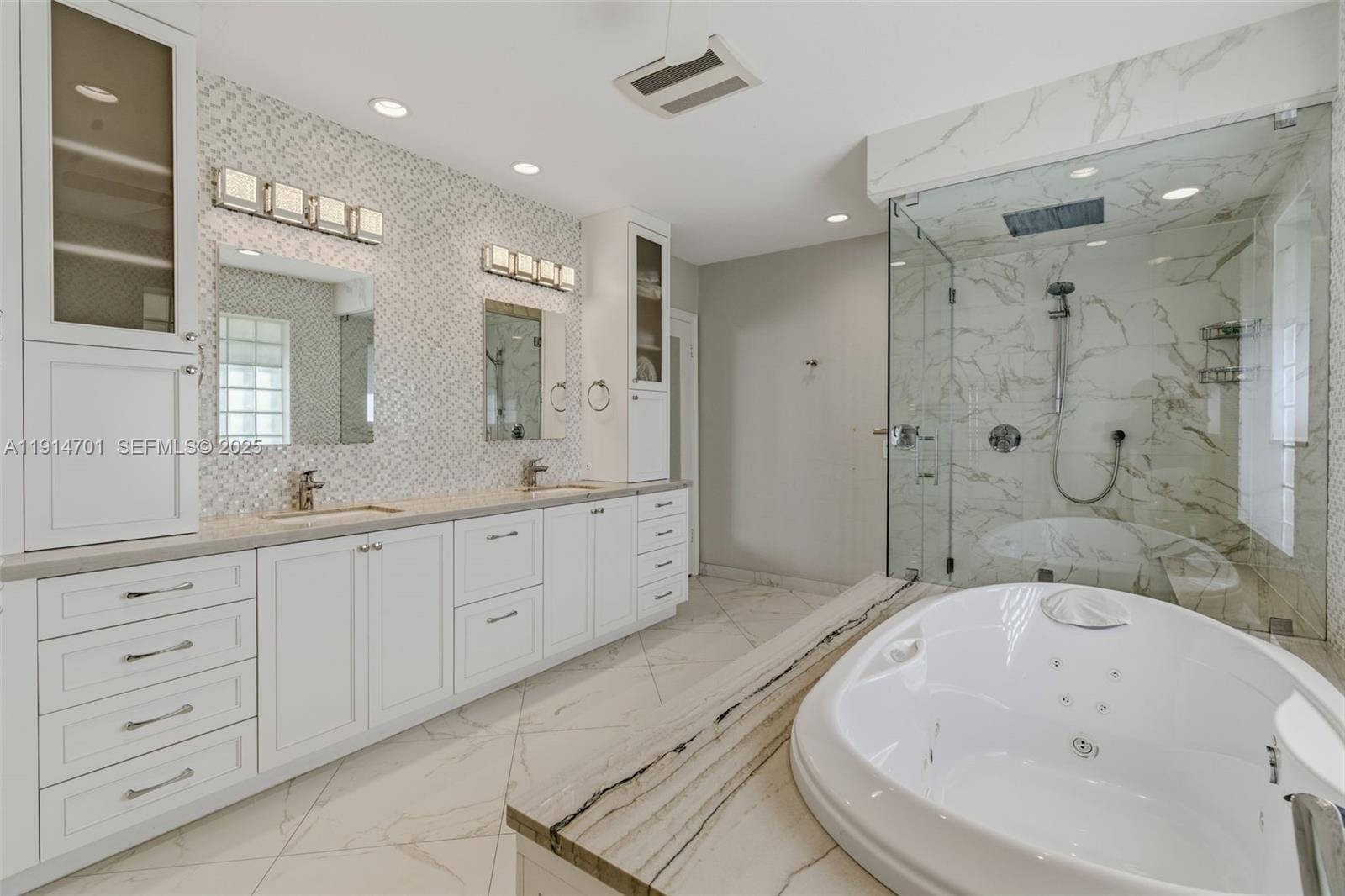 8001 Southwest 66th Terrace Miami, FL 33143 - Photo 22 of 35 a spacious bathroom with a granite countertop sink a mirror a bathtub and shower