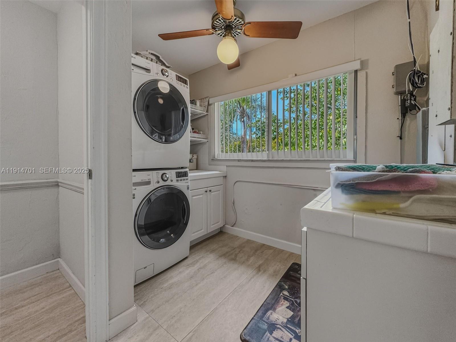 8001 Southwest 66th Terrace Miami, FL 33143 - Photo 28 of 35 a utility room with sink dryer and washer