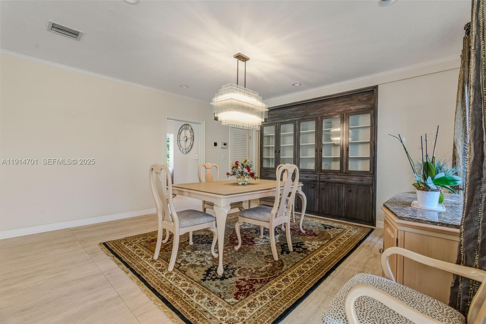 8001 Southwest 66th Terrace Miami, FL 33143 - Photo 4 of 35 a dining room with furniture a rug and a chandelier