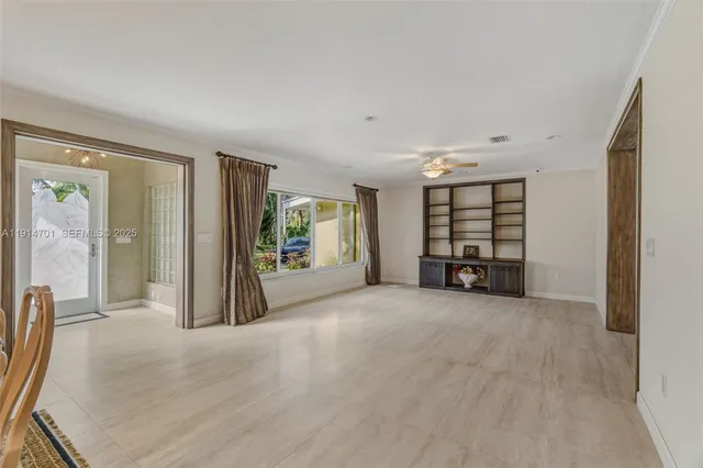 a view of an empty room with a window and balcony