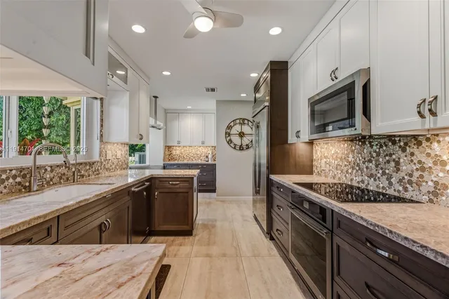 a kitchen with counter top space cabinets and stainless steel appliances