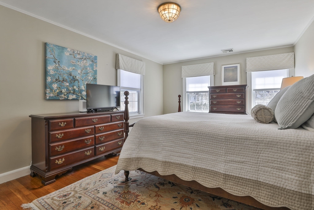 1106 Brook Road Milton, MA 02186 - Photo 14 of 25 a bedroom with a bed and a chandelier
