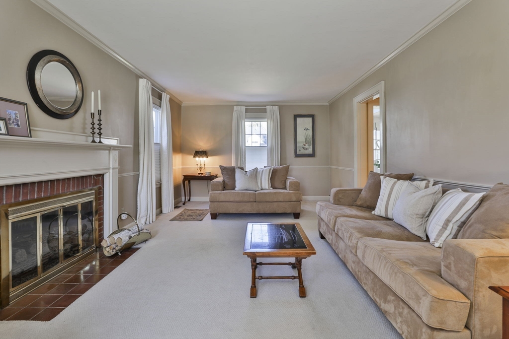 1106 Brook Road Milton, MA 02186 - Photo 3 of 25 a living room with furniture and a fireplace