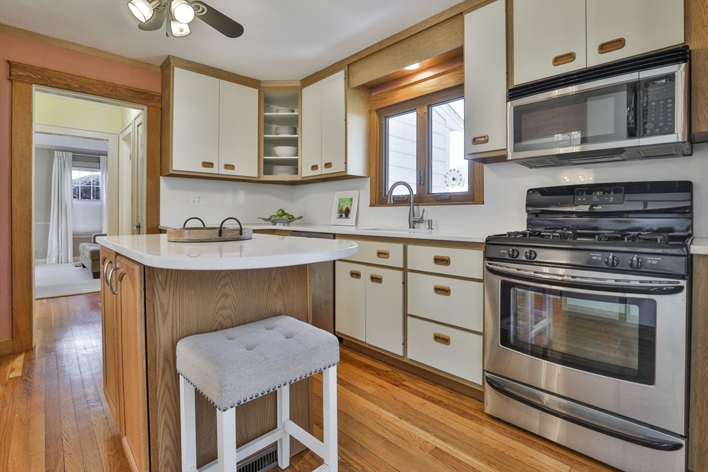 1106 Brook Road Milton, MA 02186 - Photo 4 of 25 a kitchen with stainless steel appliances a stove microwave and cabinets