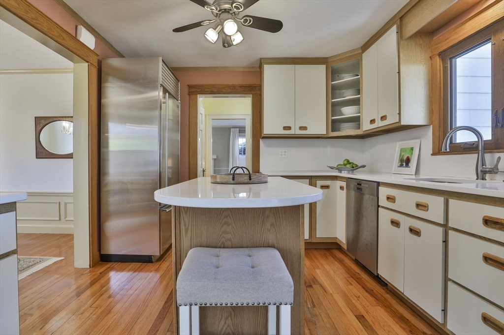 1106 Brook Road Milton, MA 02186 - Photo 5 of 25 a kitchen with stainless steel appliances granite countertop a sink dishwasher and a stove with wooden floor
