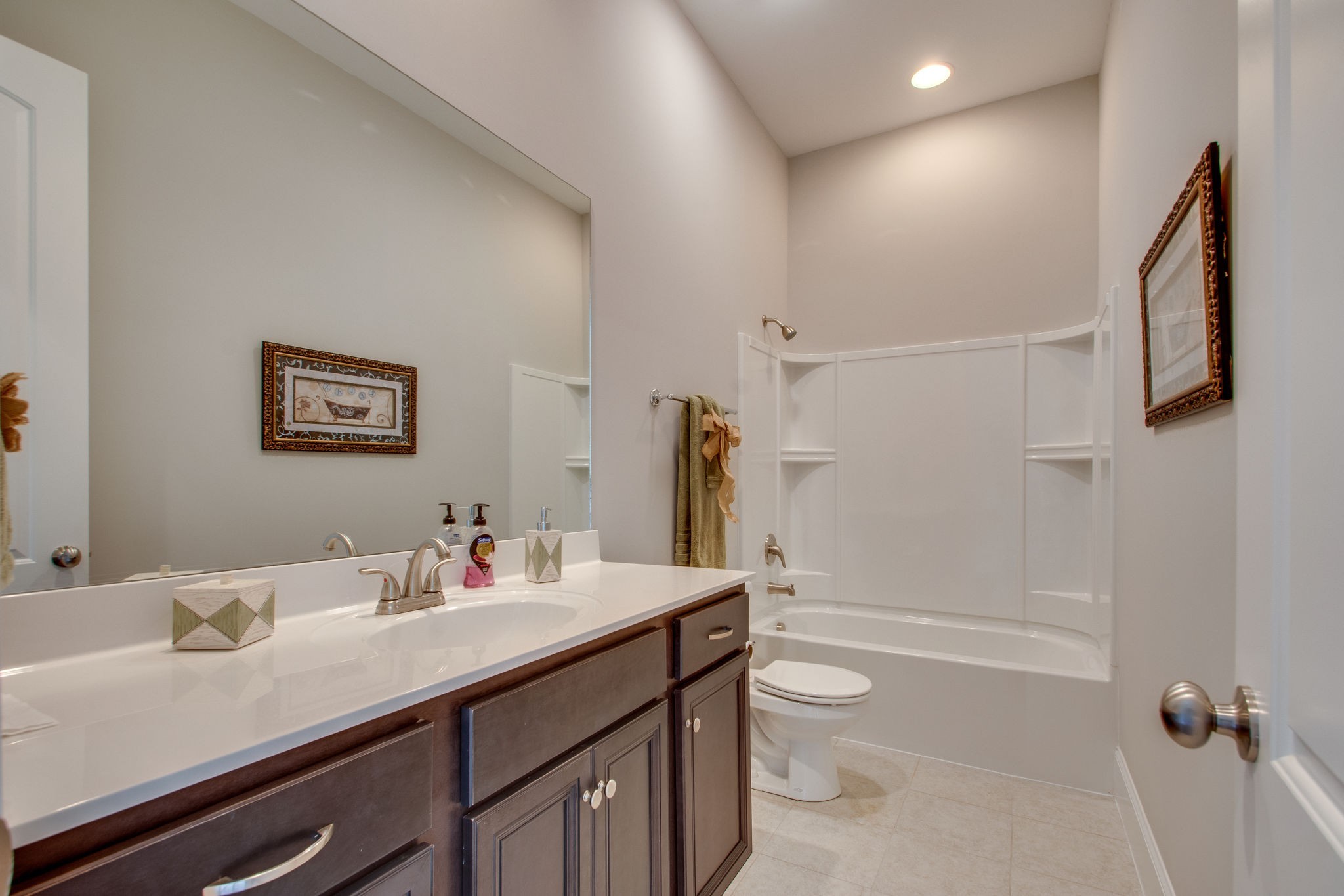 966 Hunters Lane Springfield, TN 37172 - Photo 21 of 27 a bathroom with a granite countertop sink toilet a large mirror a shower and a bathtub
