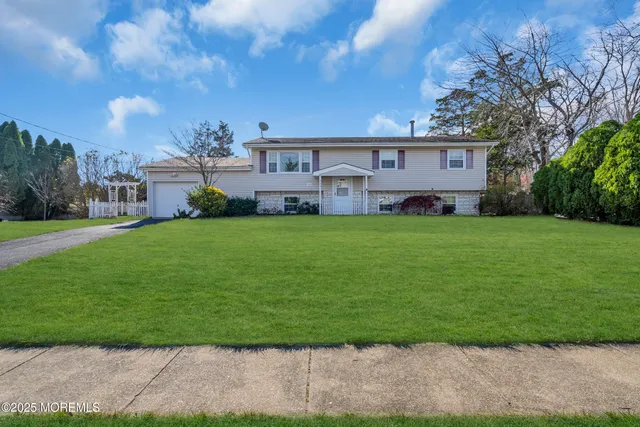 a view of a yard with a house in the background