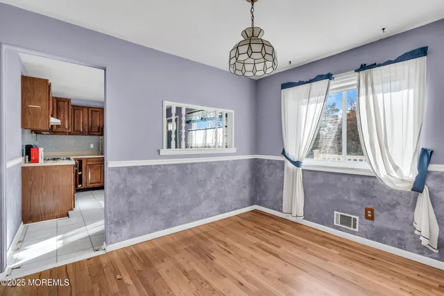 a view of a bedroom with window and furniture