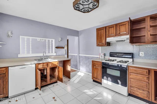 a kitchen with stainless steel appliances granite countertop a stove and a sink