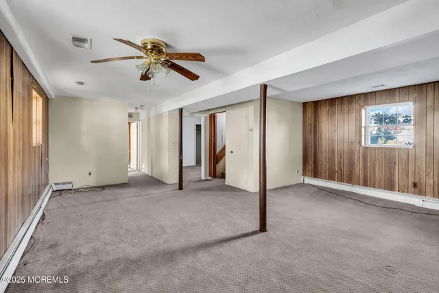 a view of a livingroom with a ceiling fan and window