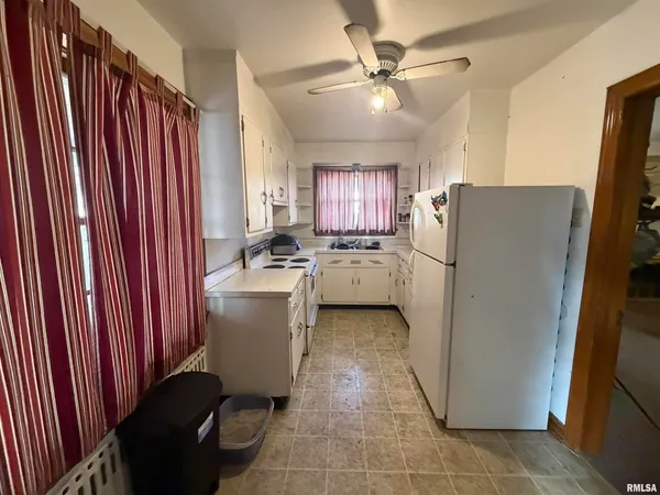 a kitchen with a refrigerator and a sink