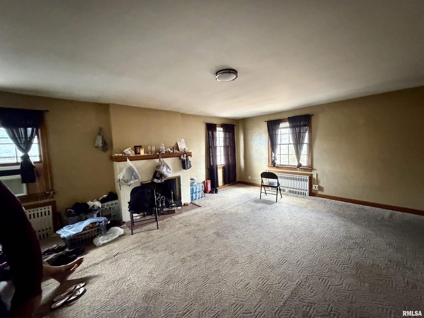 406 Cedar Street Centralia, IL 62801 - Photo 8 of 10 a view of a livingroom with a fireplace and workspace