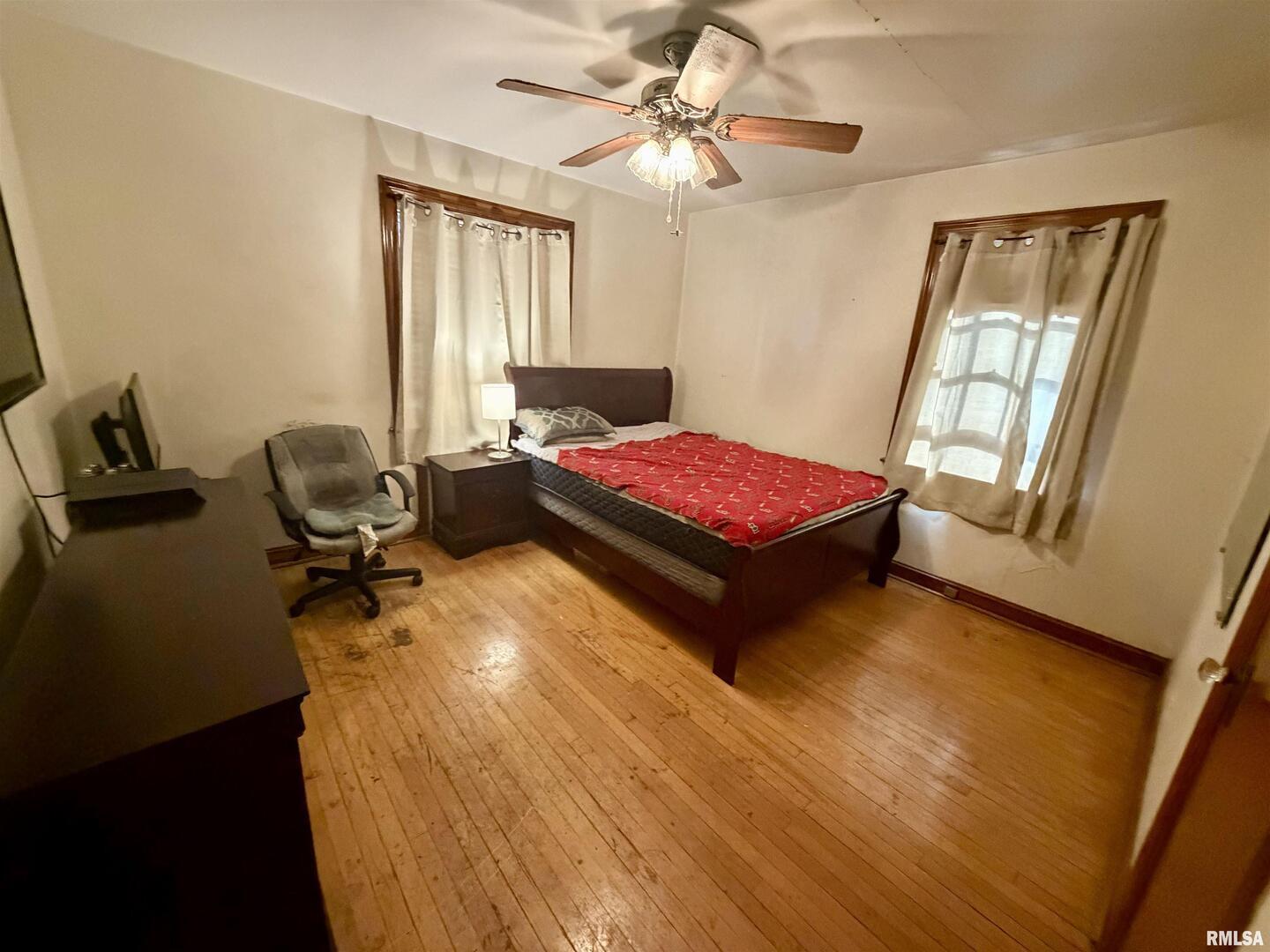 406 Cedar Street Centralia, IL 62801 - Photo 9 of 10 a bedroom with a bed and wooden floor