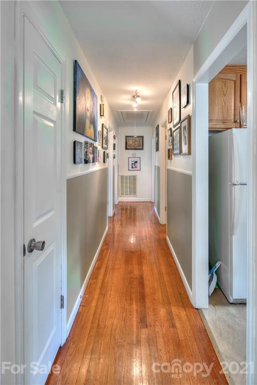 118 Eller Road Gastonia, NC 28056 - Photo 9 of 21 a view of a hallway with wooden floor and staircase