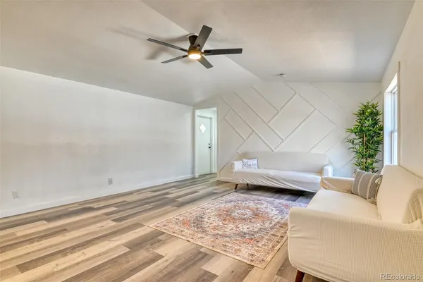 a living room with furniture and a potted plant