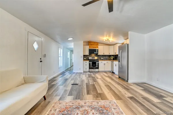 a large white kitchen with cabinets and stainless steel appliances