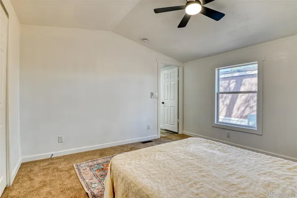 a view of a livingroom with a ceiling fan and window