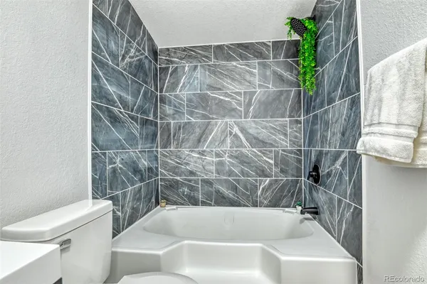 a bathroom with a bathtub and shower