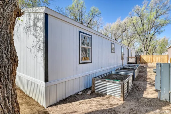 a view of a house with backyard and wooden fence