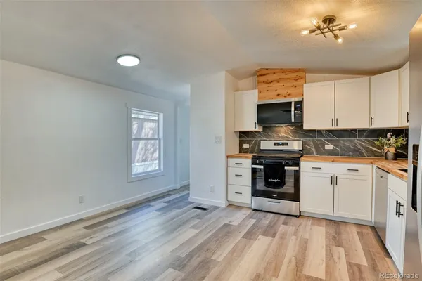 a kitchen with a stove oven and sink