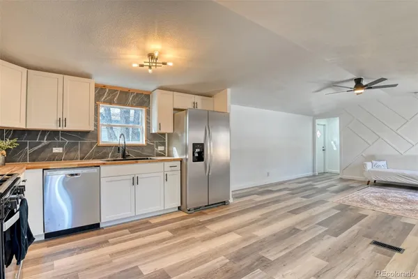 a view of a kitchen with a sink and cabinets