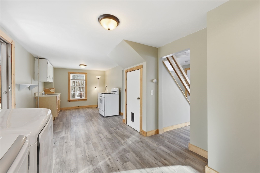 36 Sullivan Avenue Hardwick, MA 01031 - Photo 13 of 42 a view of a livingroom with wooden floor and stairs
