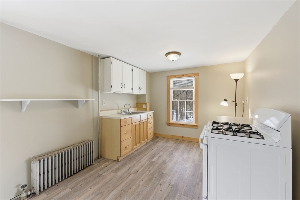 36 Sullivan Avenue Hardwick, MA 01031 - Photo 16 of 42 a kitchen with cabinets appliances a sink and a window