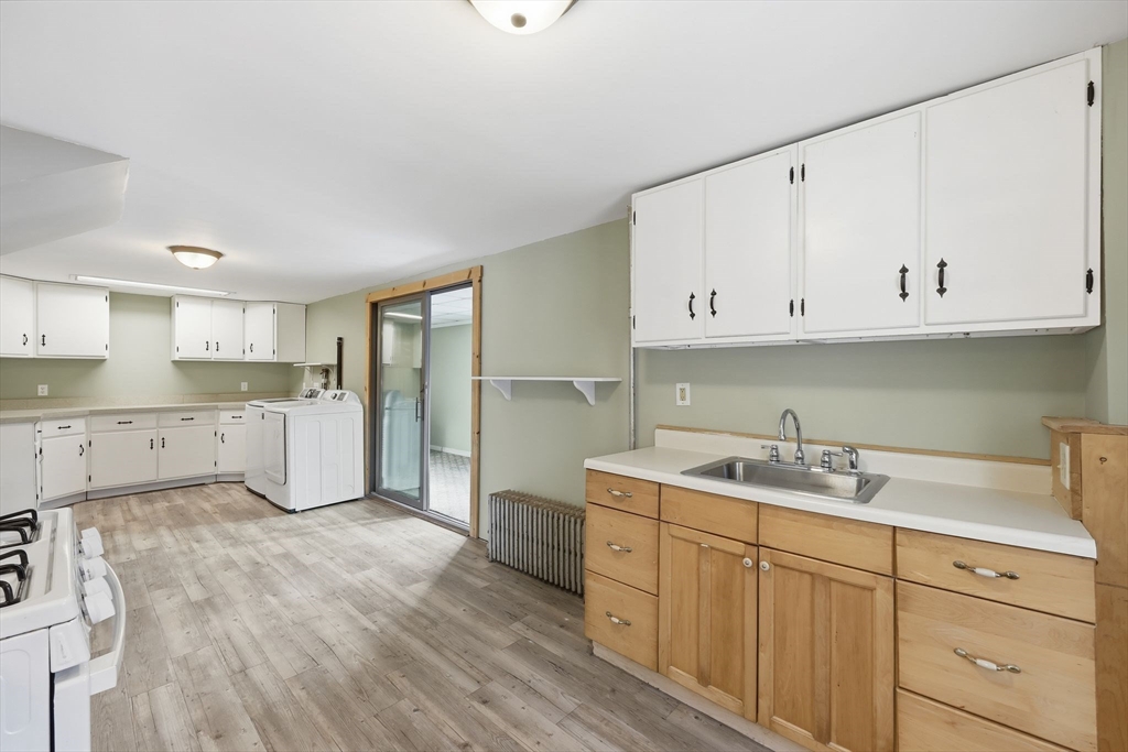 36 Sullivan Avenue Hardwick, MA 01031 - Photo 20 of 42 a kitchen with a sink dishwasher and white cabinets with wooden floor